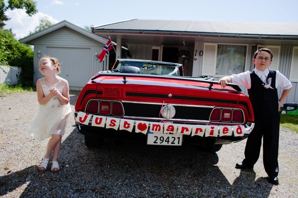Дети возле ретро-автомобиля с табличкой "Just Married"